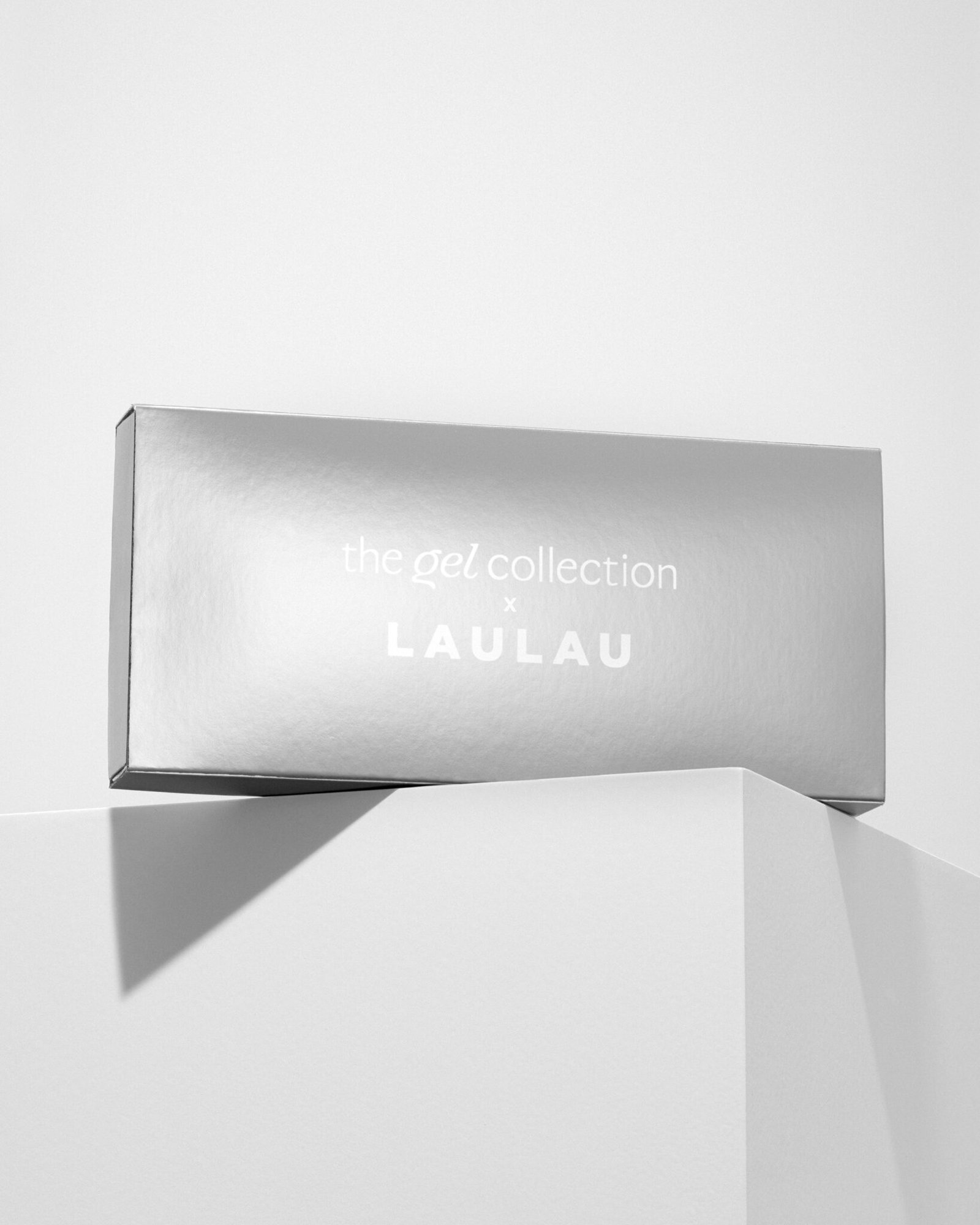 Nail polish campaign product photography in collaboration with influencer Laulau and Neglefeber. Silver box on a white block with hard shadows. Shot by product photographer Sanna Lange.