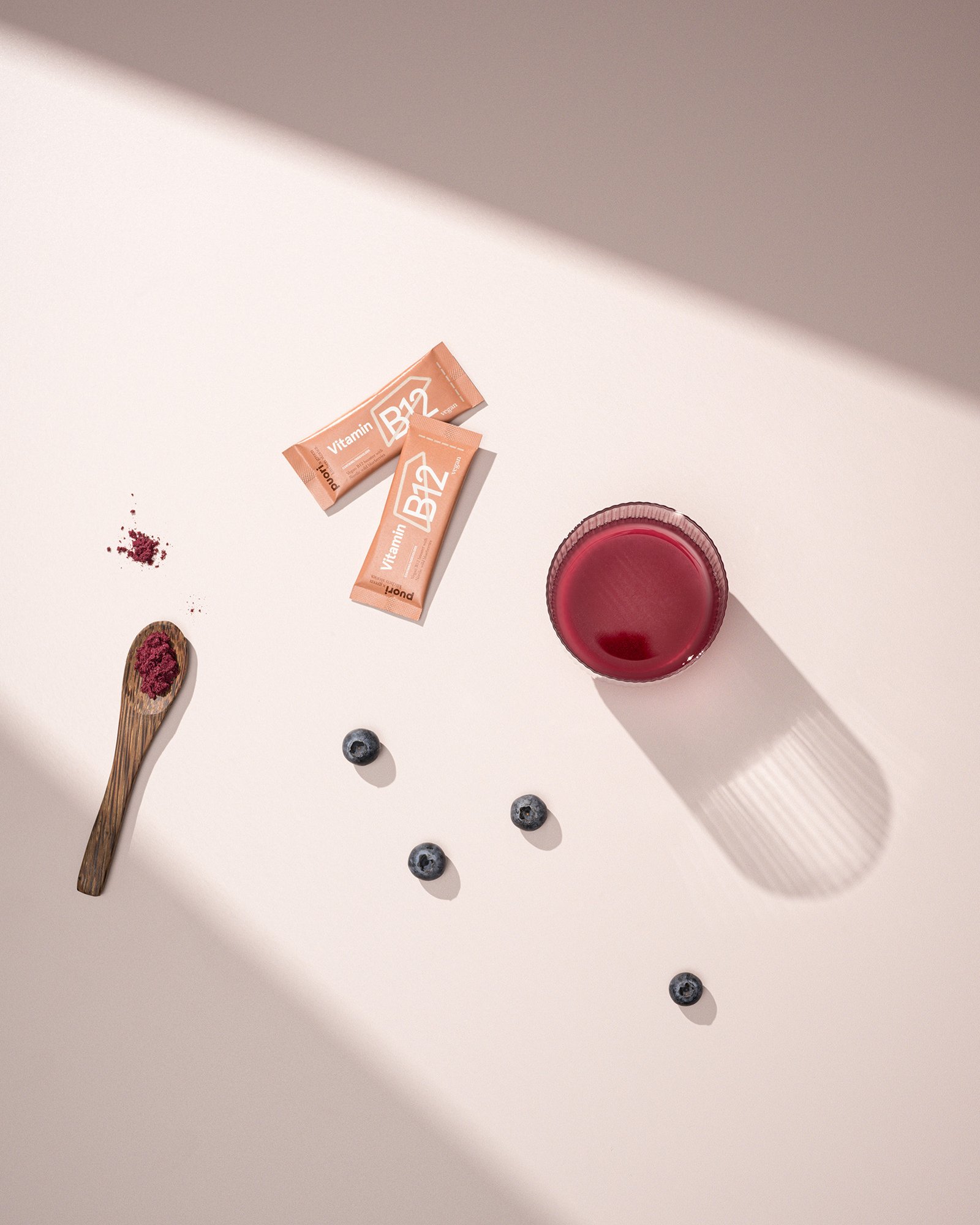 Supplements from Danish brand Puori. Creative product photography with minimalistic styling and creative shadows on a pink or nude background. By product photographer Sanna Lange.